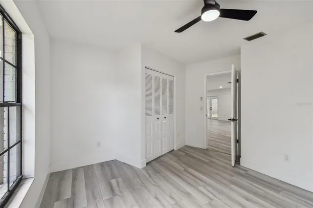 a kitchen with kitchen island white cabinets and stainless steel appliances