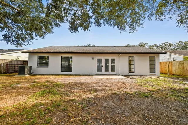 a large kitchen with stainless steel appliances granite countertop a lot of counter space and wooden floors