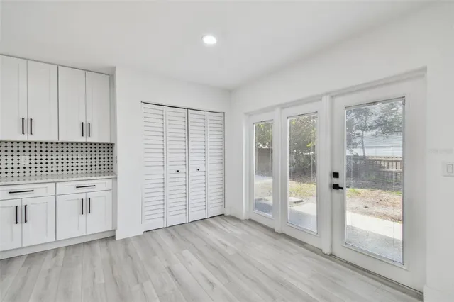 a kitchen with stainless steel appliances granite countertop a sink and a refrigerator
