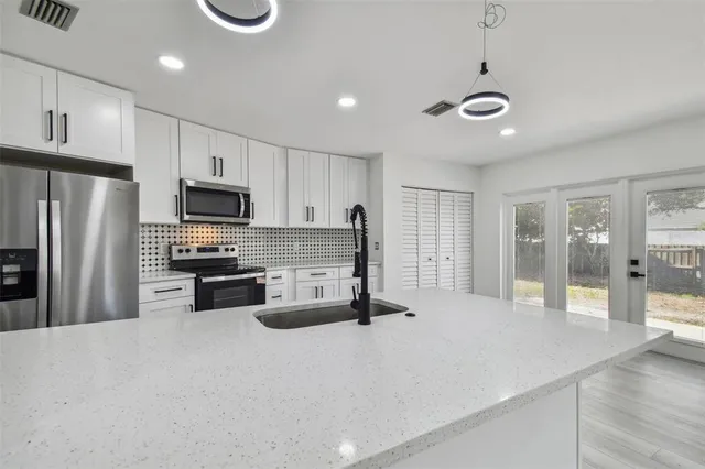 an empty room with windows and closet