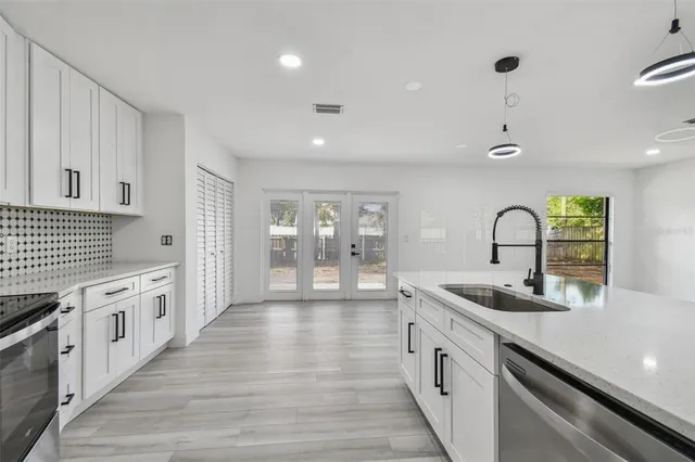 a spacious bathroom with a granite countertop sink mirror and toilet