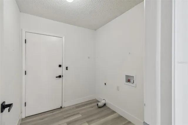 a view of empty room with wooden floor and floor to ceiling window