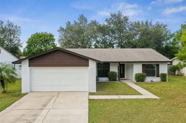 an aerial view of a house with swimming pool and mountains