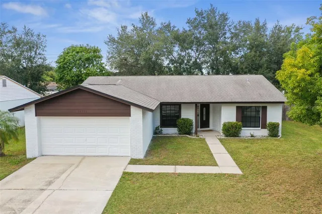an aerial view of a house with a yard and lake view