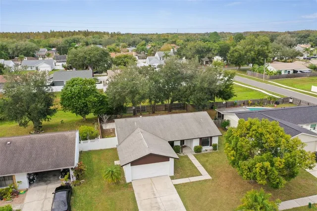 an aerial view of residential houses with outdoor space and river