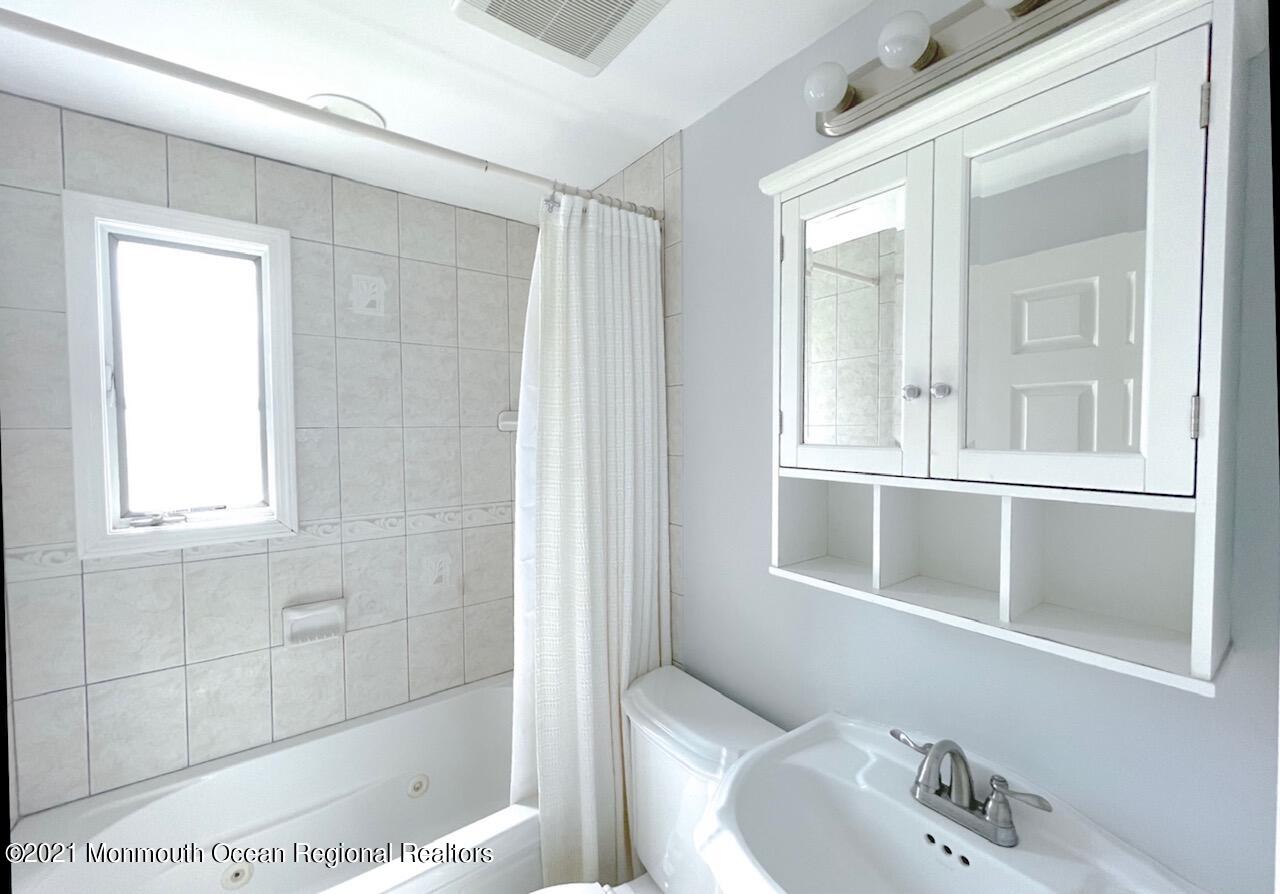 330 Front Street Union Beach, NJ 07735 - Photo 11 of 23 a bathroom with a bathtub and a sink
