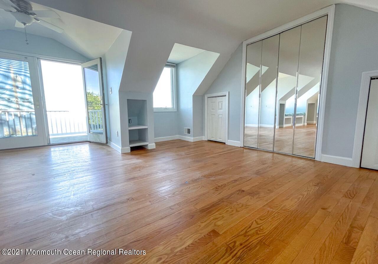 330 Front Street Union Beach, NJ 07735 - Photo 16 of 23 a view of an empty room with wooden floor and a window