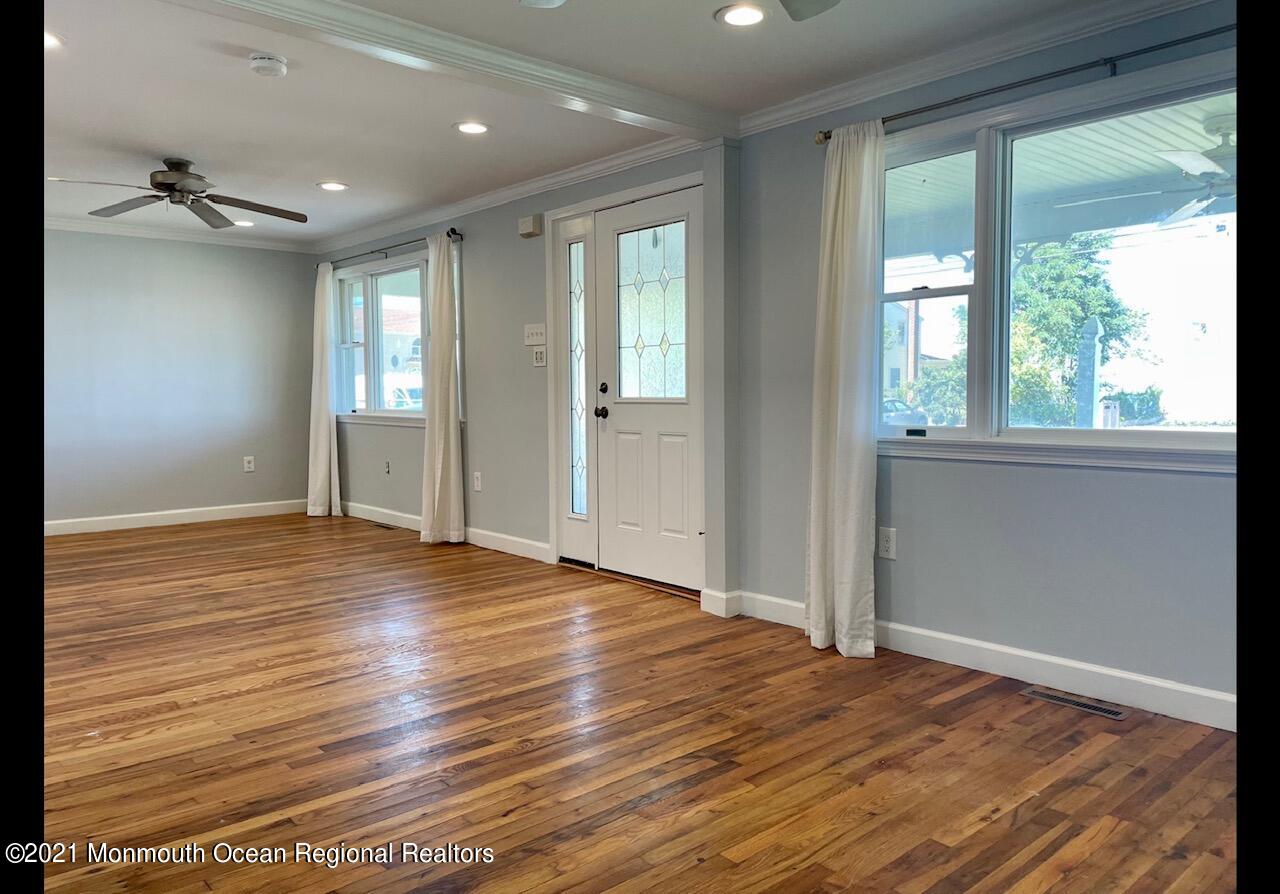 330 Front Street Union Beach, NJ 07735 - Photo 5 of 23 a view of an empty room with wooden floor and a window