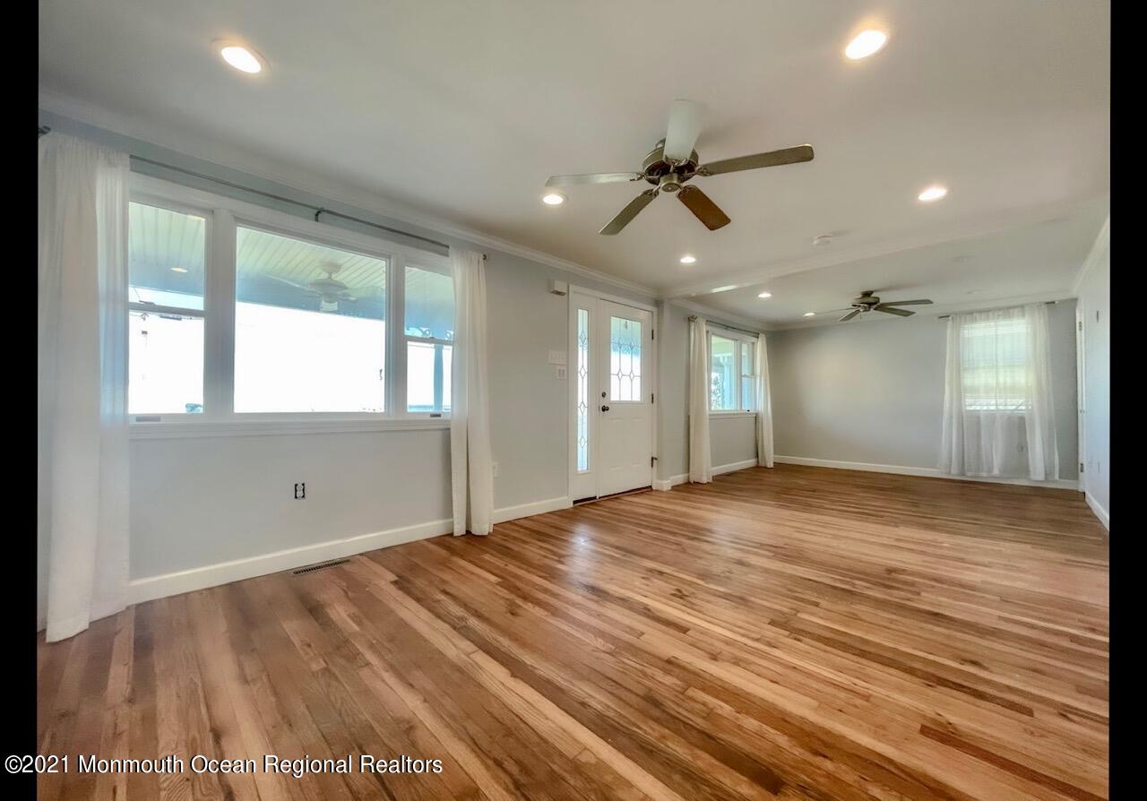 330 Front Street Union Beach, NJ 07735 - Photo 6 of 23 a view of an empty room with window and wooden floor