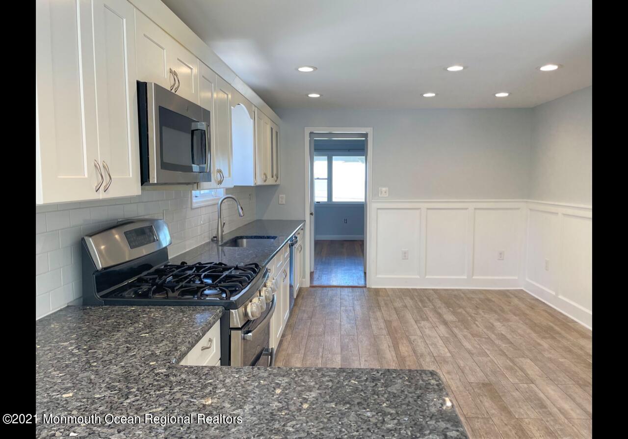 330 Front Street Union Beach, NJ 07735 - Photo 9 of 23 a kitchen with stainless steel appliances granite countertop a stove a sink and a microwave