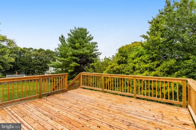 a view of balcony with wooden floor and fence