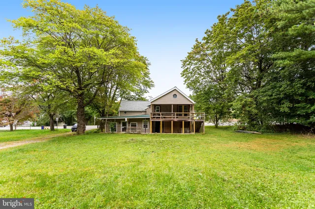 a view of a house with yard and sitting area