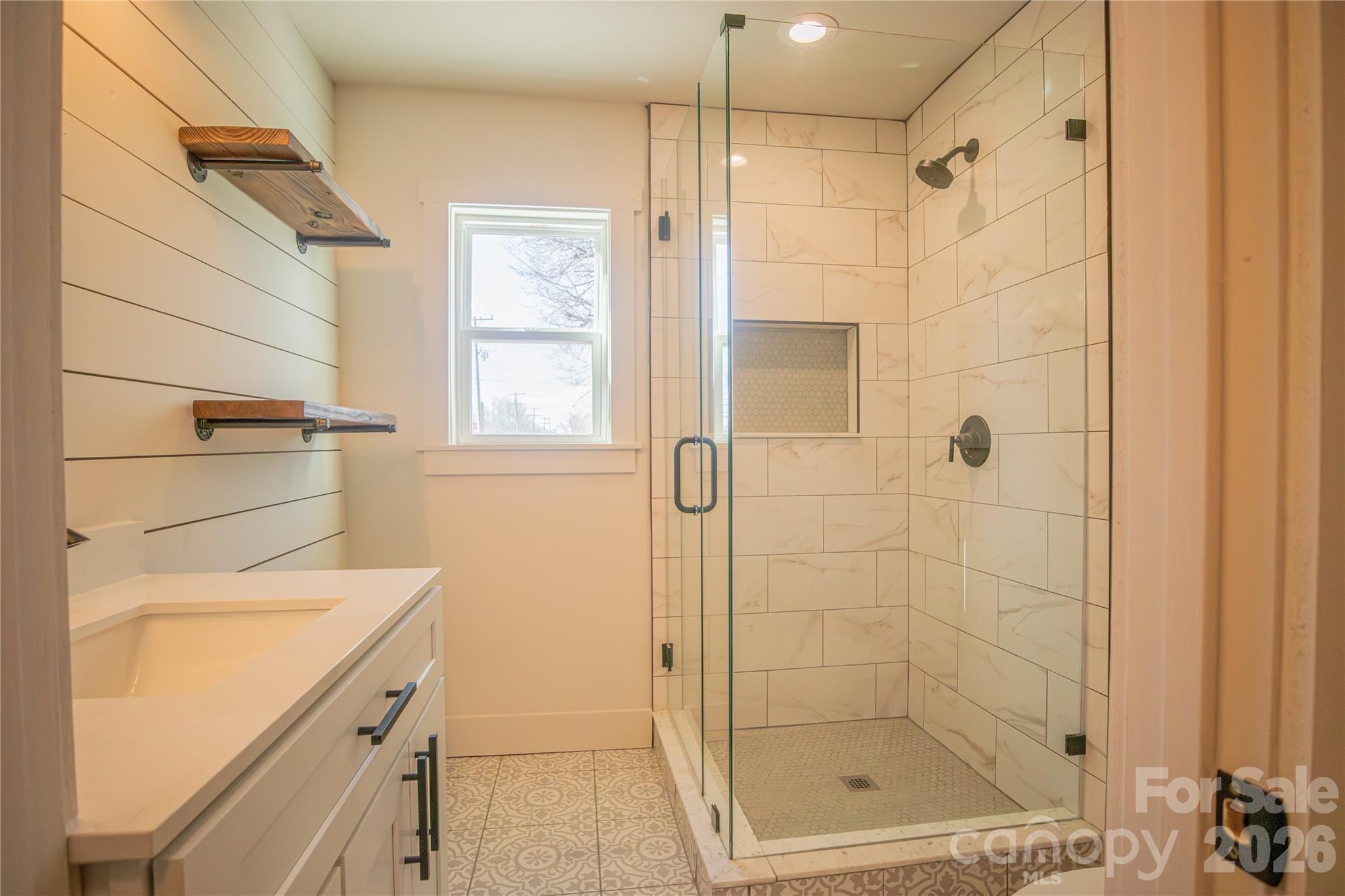 929 South Long Street Salisbury, NC 28144 - Photo 18 of 30 a bathroom with a shower and a sink a mirror