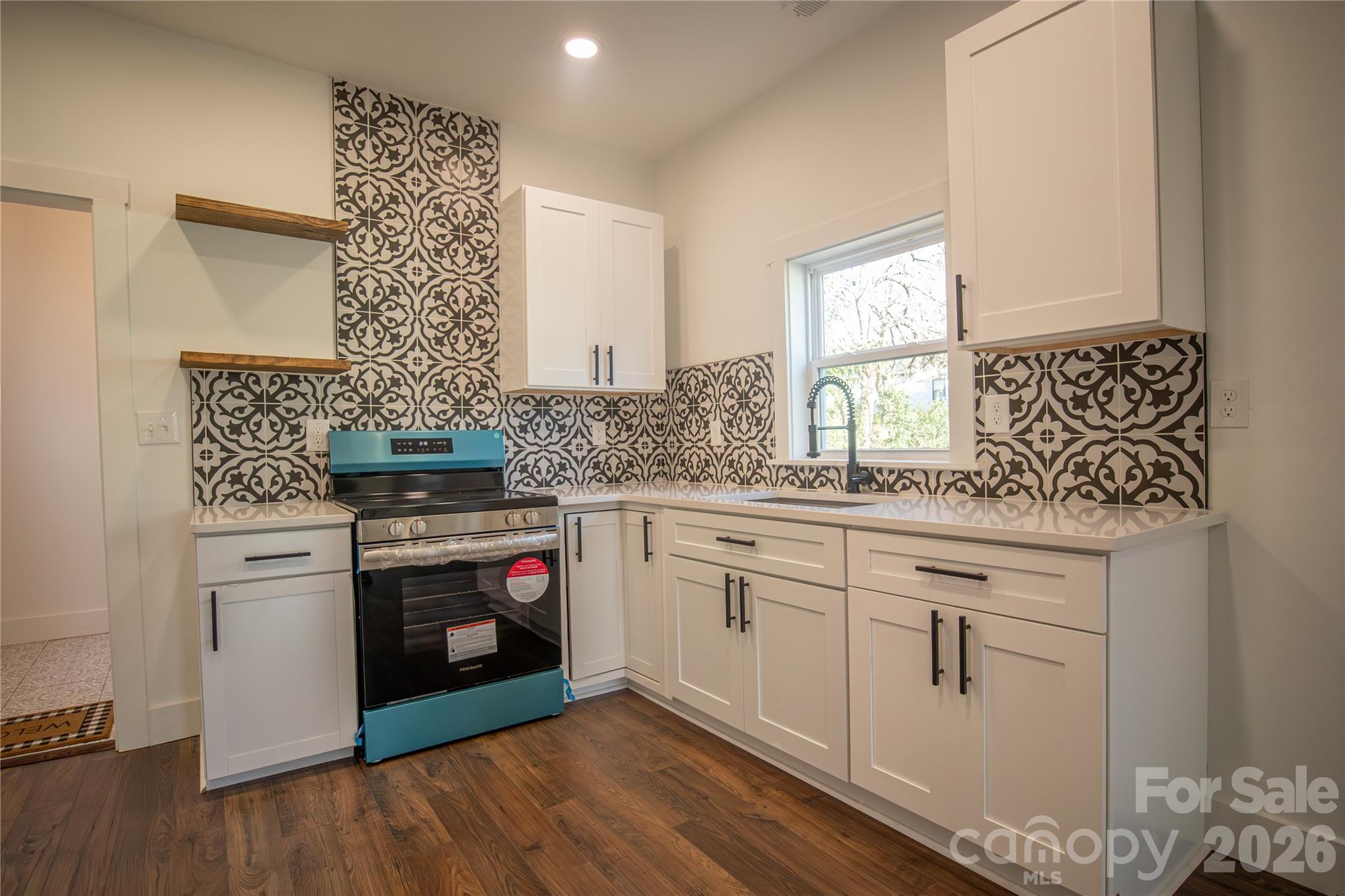 929 South Long Street Salisbury, NC 28144 - Photo 29 of 30 a kitchen with stainless steel appliances granite countertop a stove and a sink