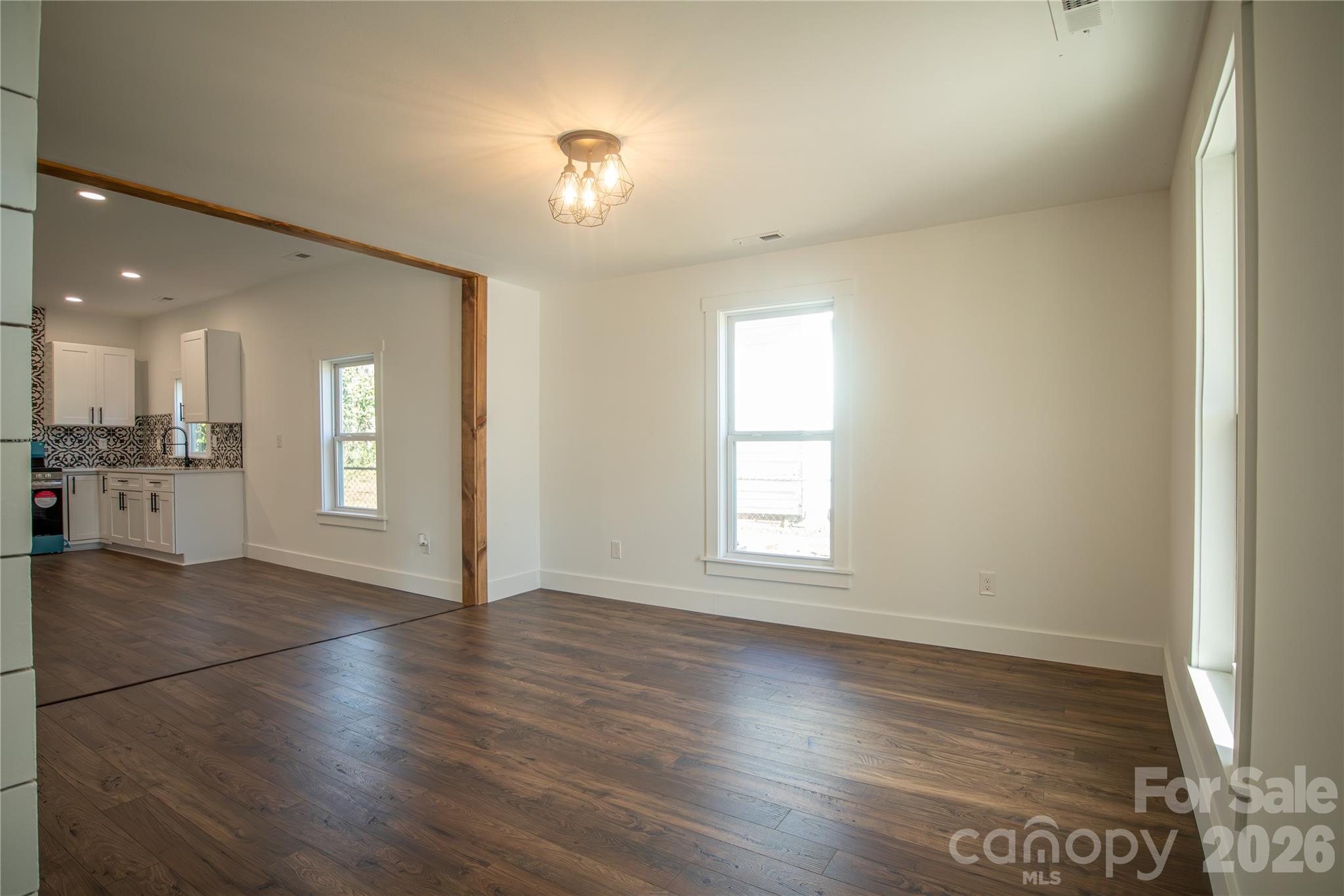 929 South Long Street Salisbury, NC 28144 - Photo 7 of 30 an empty room with wooden floor and windows