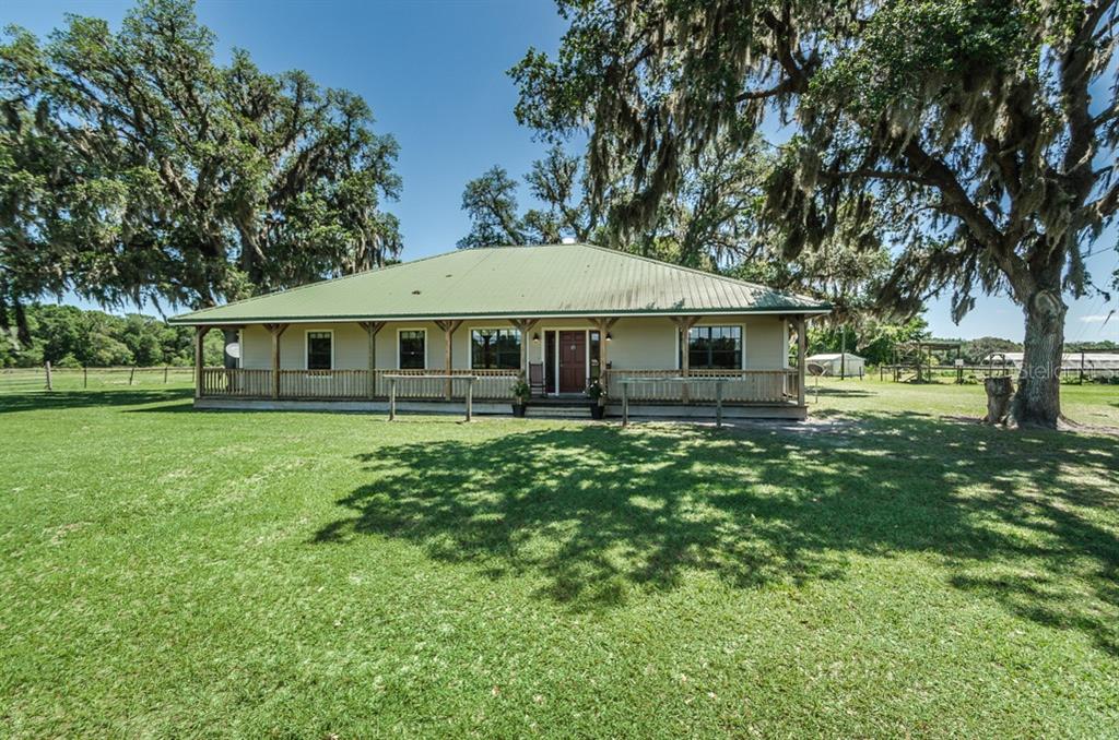 17495 Squirrel Prairie Road Brooksville, FL 34604 - Photo 1 of 1 Front of house with full length porch