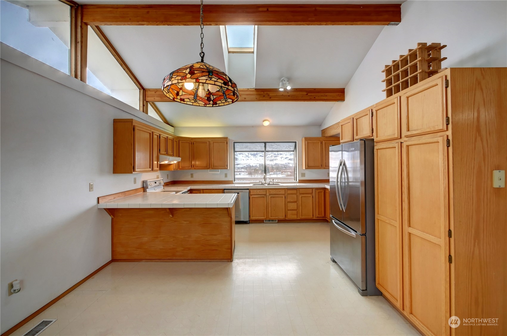 10 Sunrise Heights Road Malott, WA 98840 - Photo 18 of 40 a kitchen with stainless steel appliances granite countertop a chimney a sink and a refrigerator