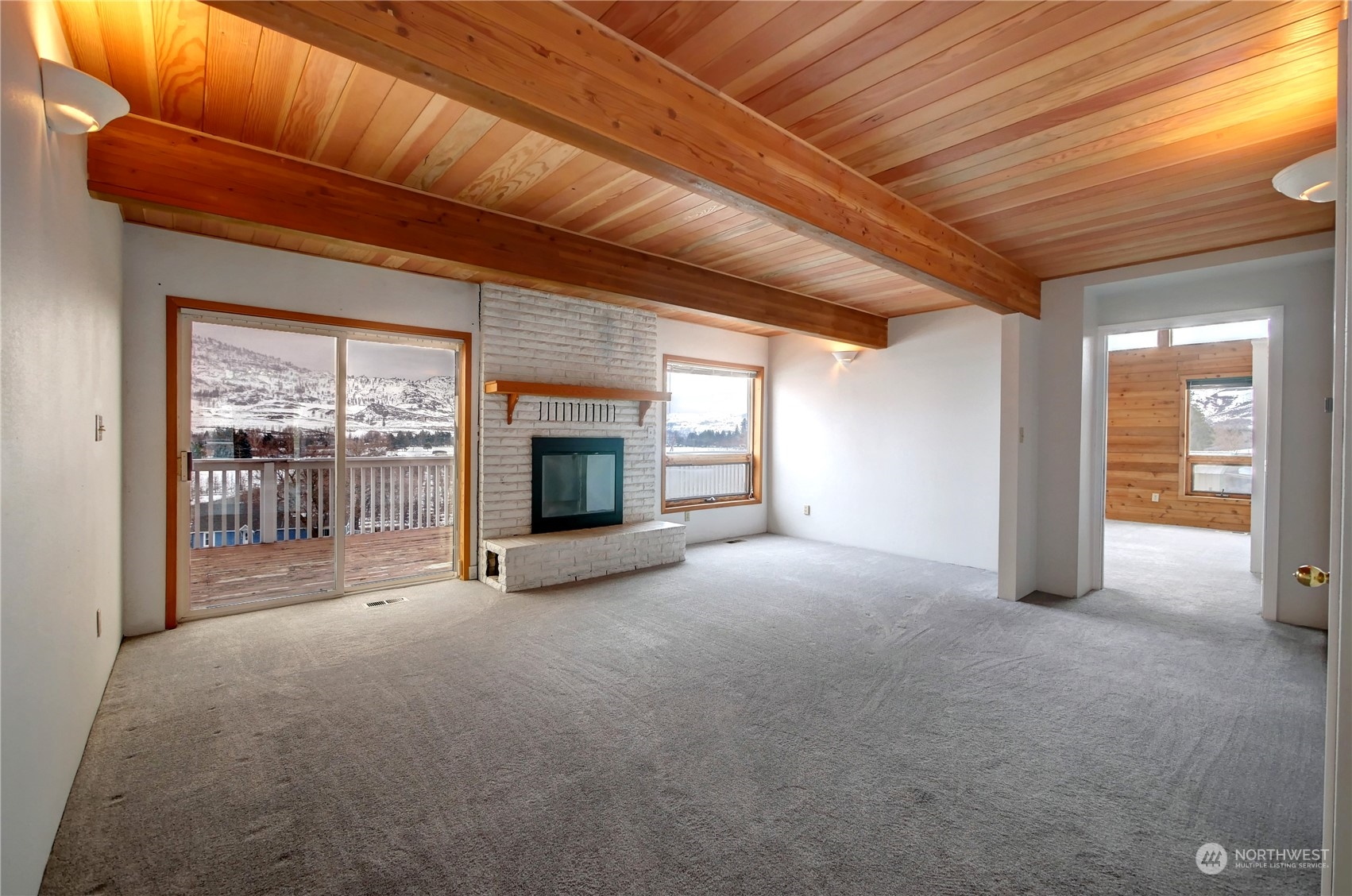 10 Sunrise Heights Road Malott, WA 98840 - Photo 23 of 40 a view of empty room with floor to ceiling window and fireplace