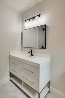 a bathroom with a sink and mirror