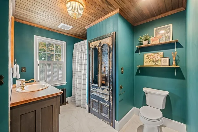 a bathroom with a toilet a sink and mirror