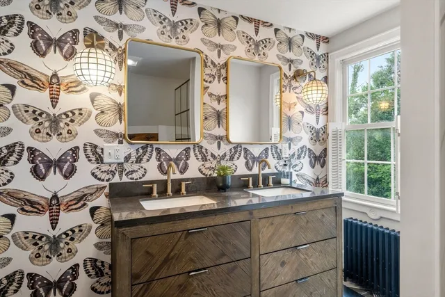 a bathroom with a sink double vanity and a mirror