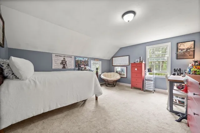 a bed room with a bed and a chair