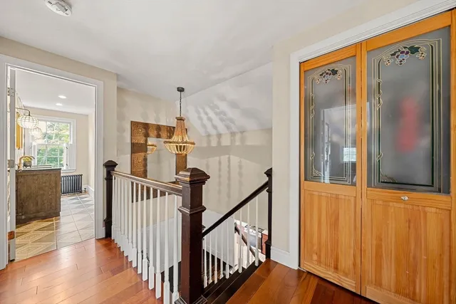 a view of a entryway with wooden floor and stairs