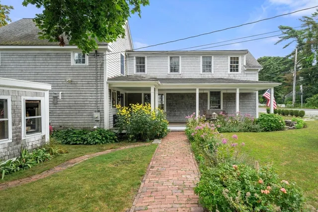 a front view of a house with garden and porch