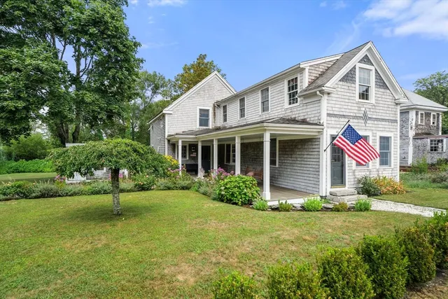 a view of a house with a yard and plants