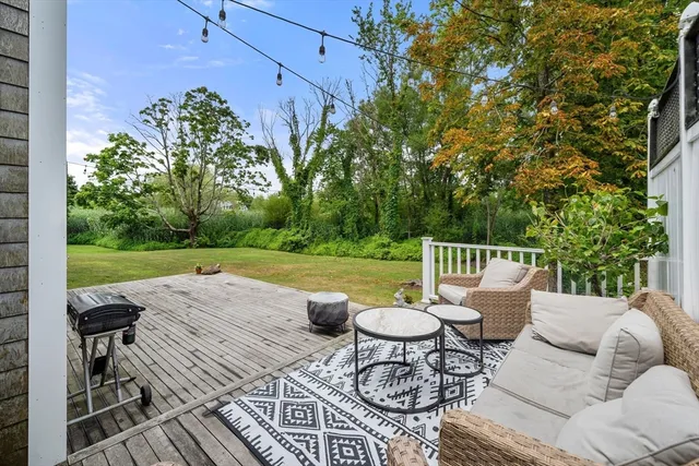 a view of a chairs and table in backyard