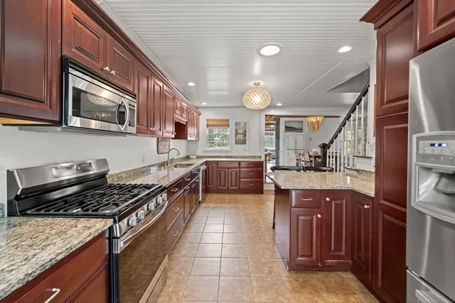 a kitchen with stainless steel appliances granite countertop a stove and a sink