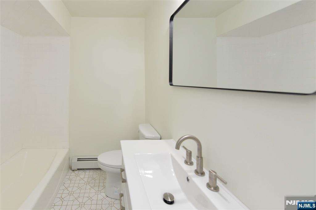 60 Poplar Avenue Hackensack, NJ 07601 - Photo 12 of 21 a bathroom with a sink and a toilet