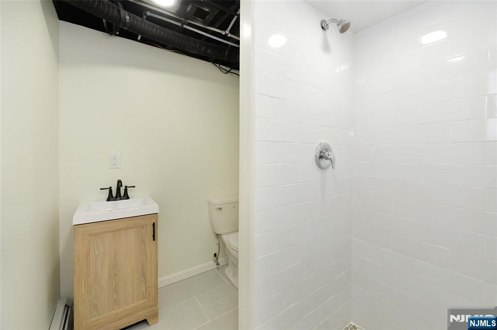 60 Poplar Avenue Hackensack, NJ 07601 - Photo 18 of 21 a bathroom with a sink toilet and shower