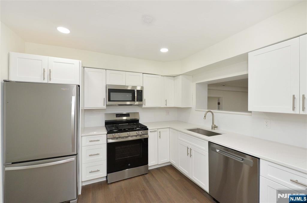60 Poplar Avenue Hackensack, NJ 07601 - Photo 3 of 21 a kitchen with stainless steel appliances a refrigerator stove and sink
