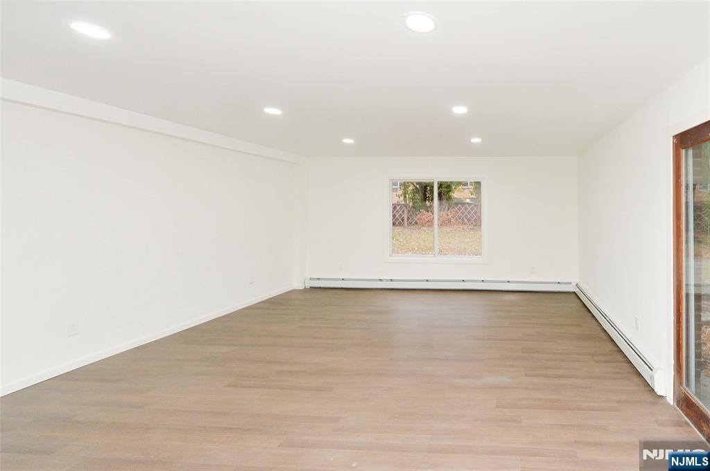 60 Poplar Avenue Hackensack, NJ 07601 - Photo 4 of 21 a view of an empty room with wooden floor and a window