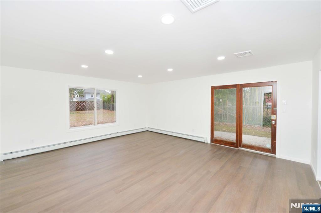 60 Poplar Avenue Hackensack, NJ 07601 - Photo 6 of 21 an empty room with wooden floor and window
