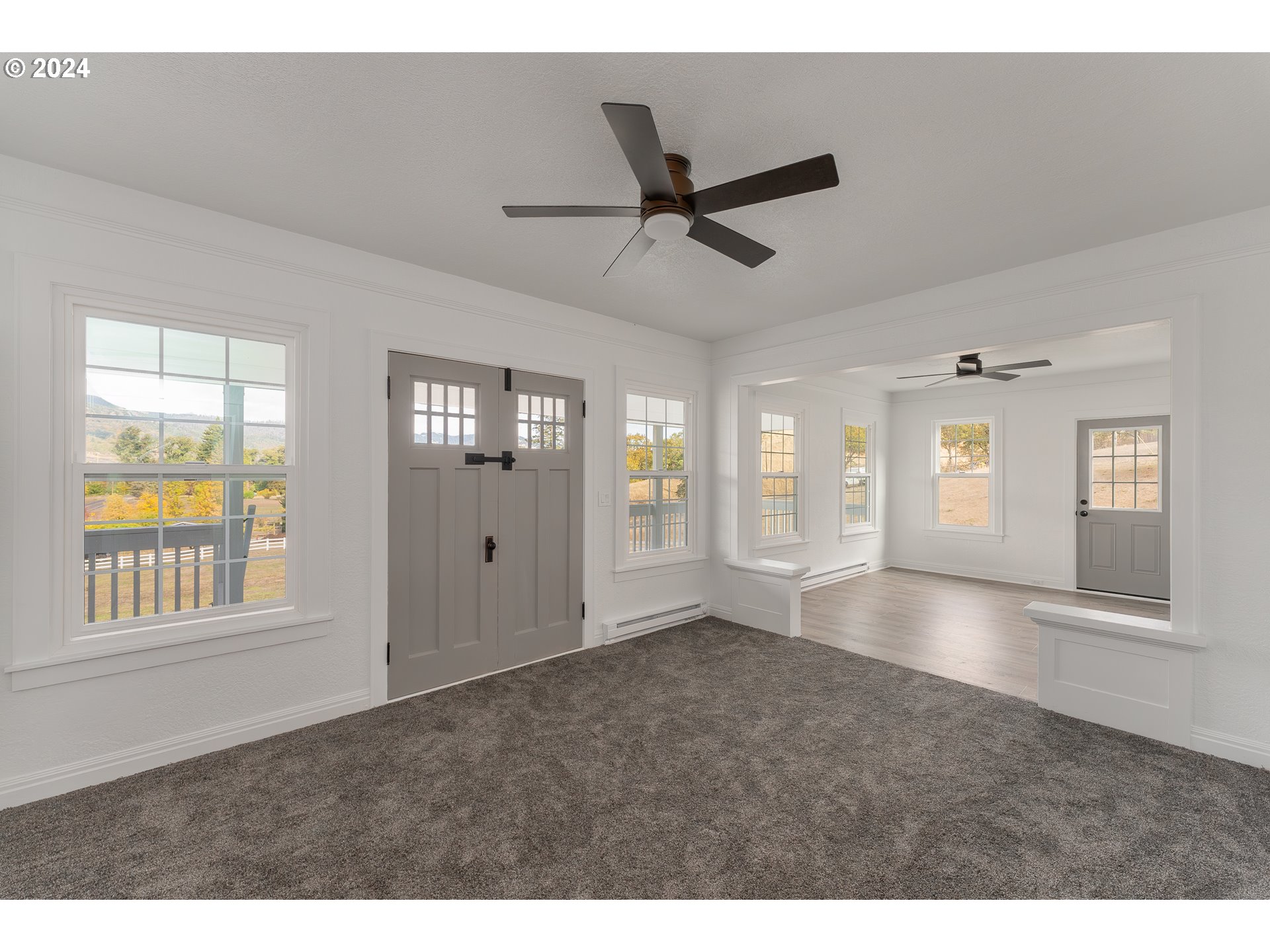 754 Glenbrook Loop Road Riddle, OR 97469 - Photo 12 of 45 a view of an empty room with window and wooden floor