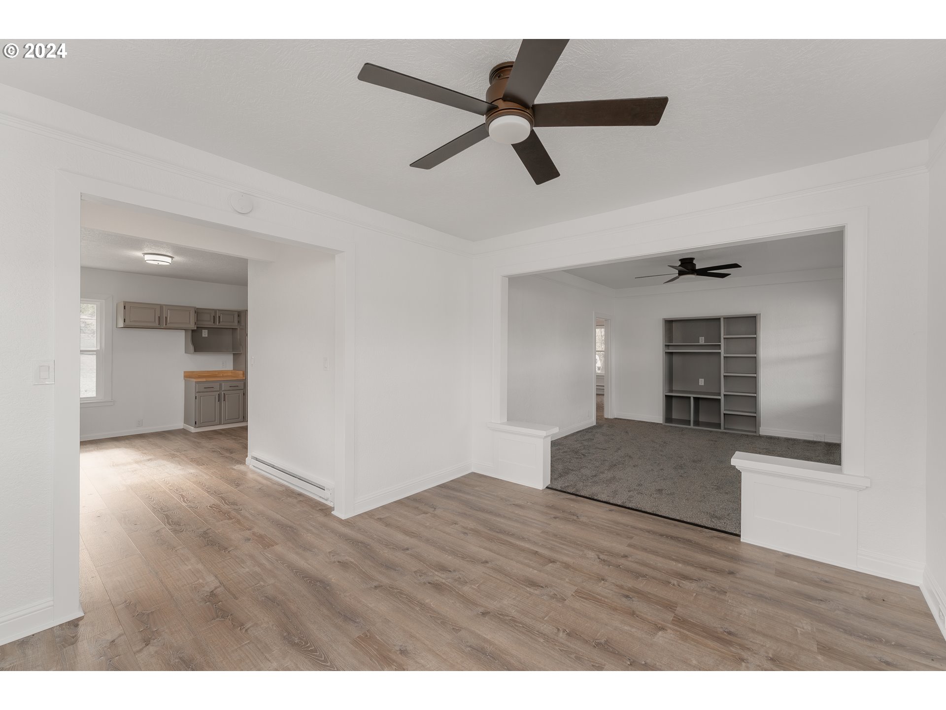 754 Glenbrook Loop Road Riddle, OR 97469 - Photo 13 of 45 a view of empty room with wooden floor and ceiling fan