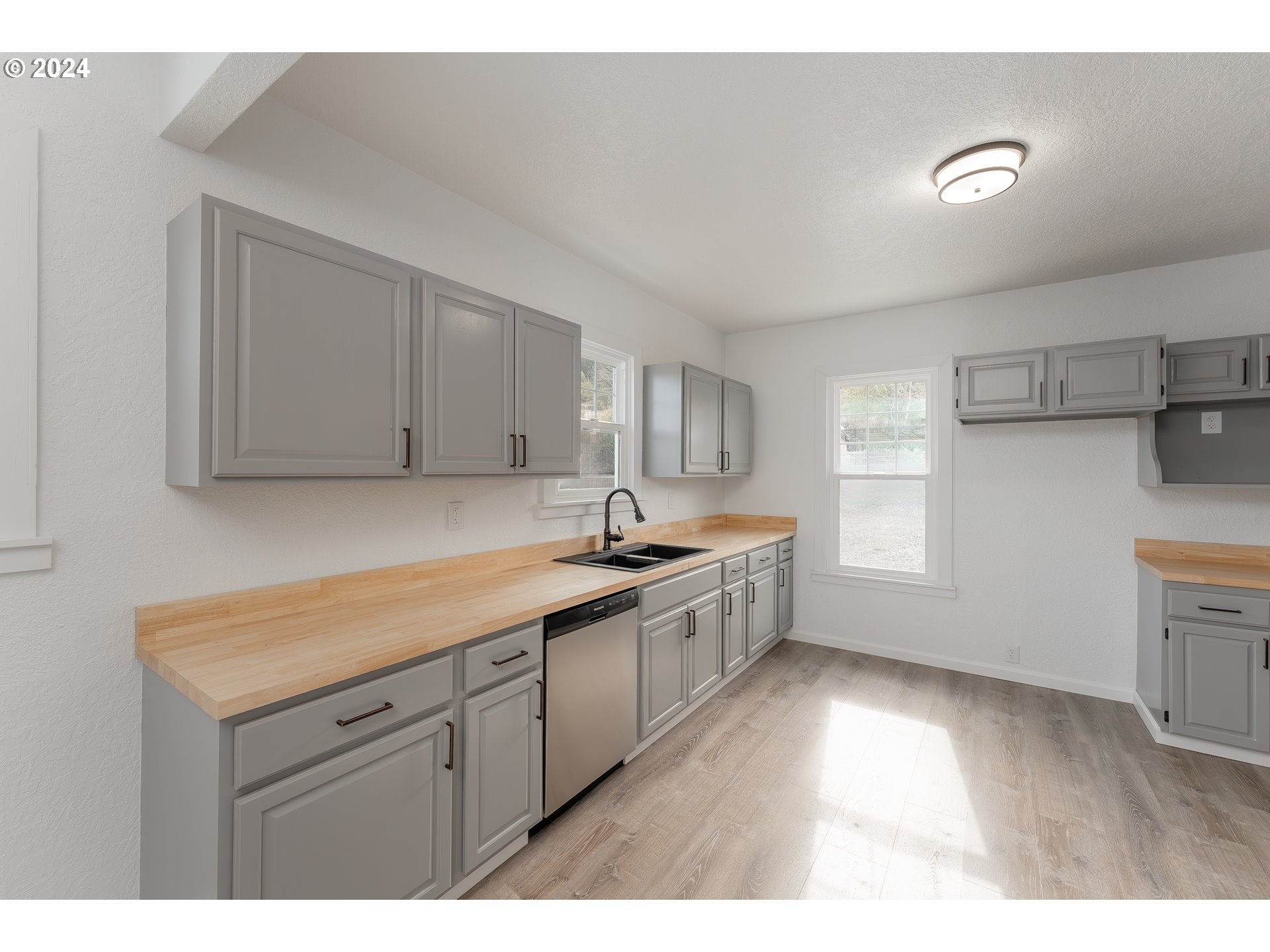 754 Glenbrook Loop Road Riddle, OR 97469 - Photo 16 of 45 a kitchen with a sink cabinets and window