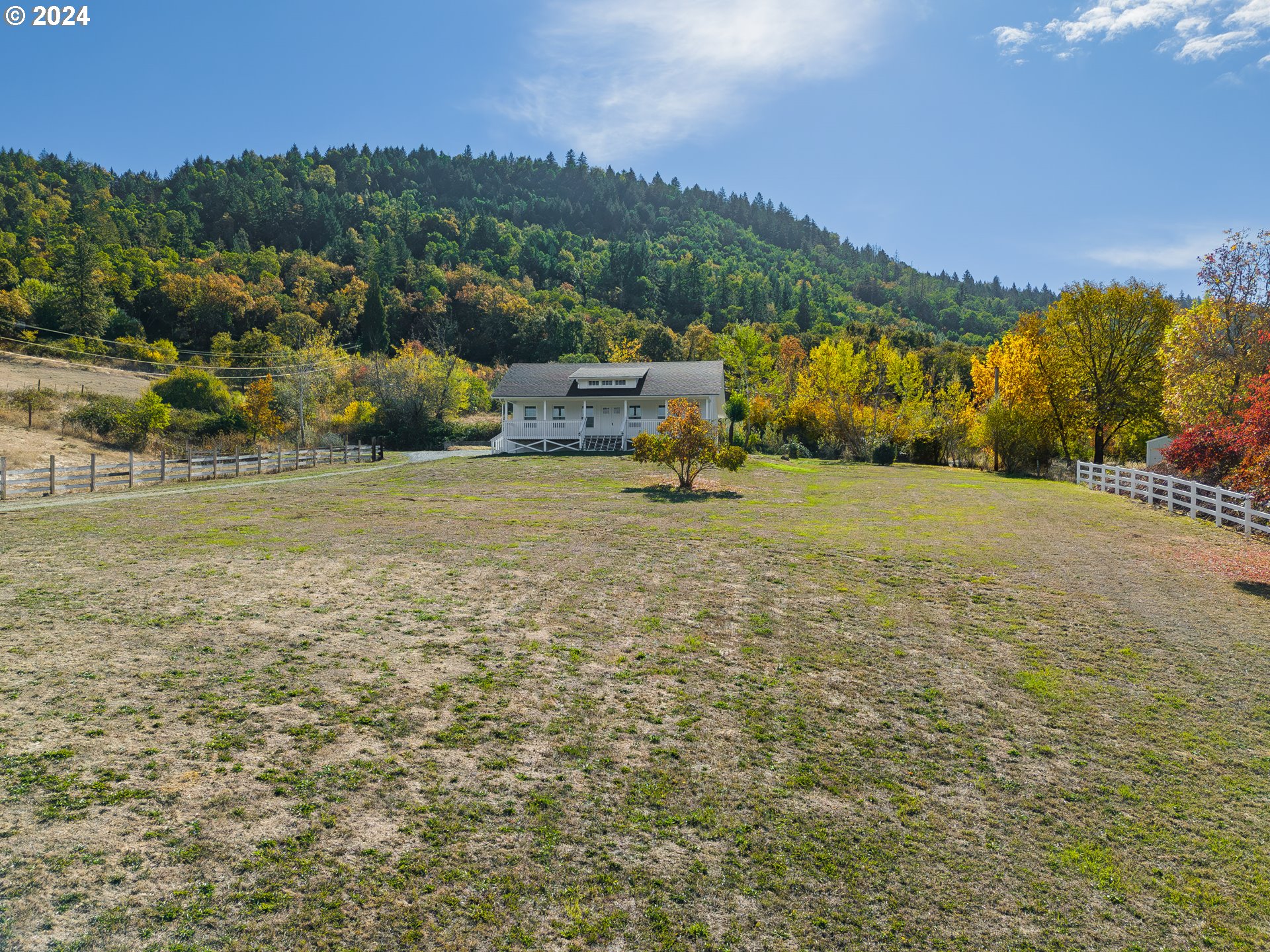 754 Glenbrook Loop Road Riddle, OR 97469 - Photo 38 of 45 an aerial view of residential houses with outdoor space and trees