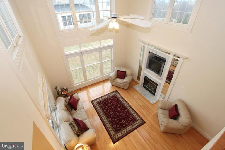 14311 Bubbling Spring Road Boyds, MD 20841 - Photo 8 of 23 a living room with furniture and a fireplace