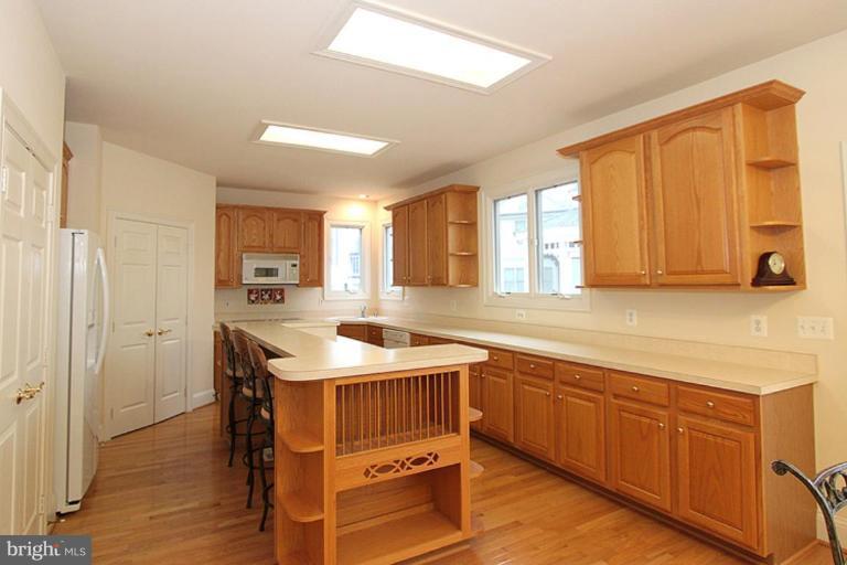 14311 Bubbling Spring Road Boyds, MD 20841 - Photo 9 of 23 a kitchen with a sink stove and cabinets