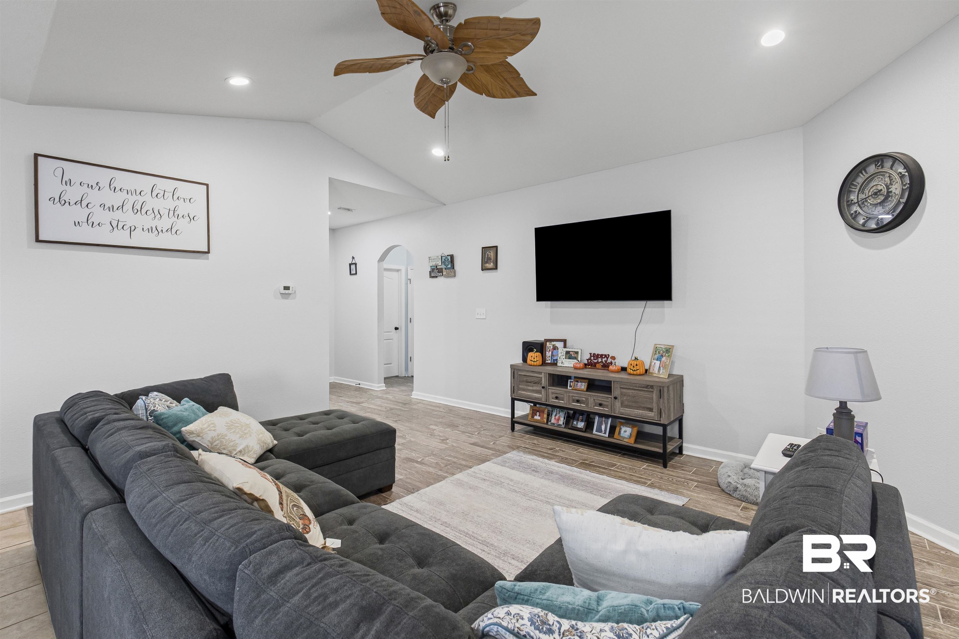 4107 Nottingham Drive Semmes, AL 36575 - Photo 8 of 23 Living area with lofted ceiling, arched walkways, ceiling fan, wood finished floors, and recessed lighting