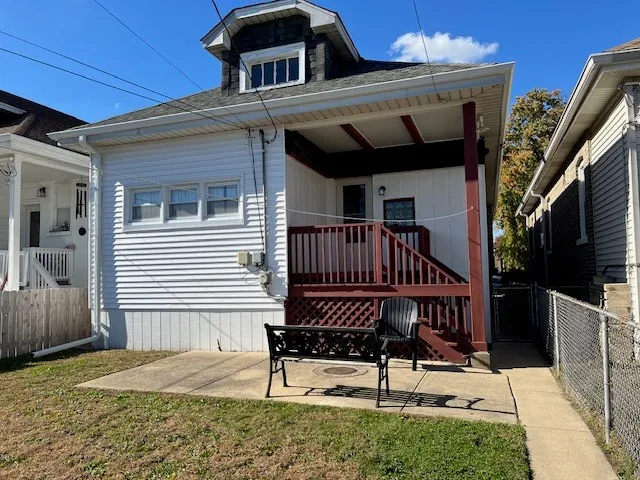 a view of a house with a wooden deck