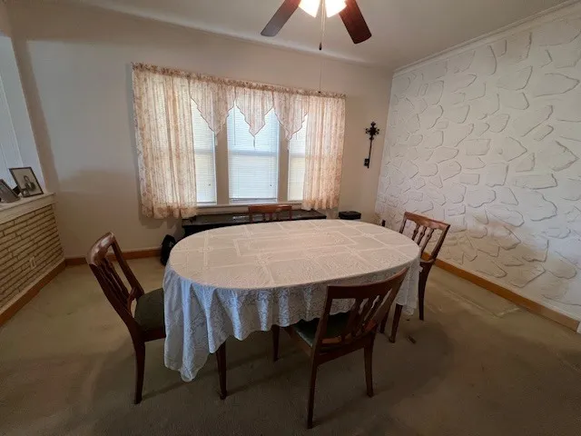 a dining room with furniture and window