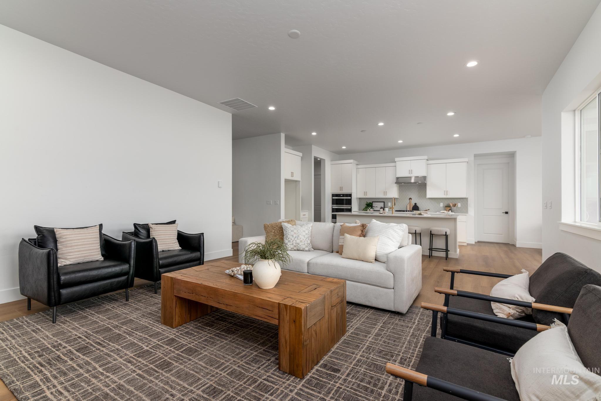 8558 South Silver Smog Way Meridian, ID 83642 - Photo 3 of 13 Living area featuring dark wood finished floors and recessed lighting