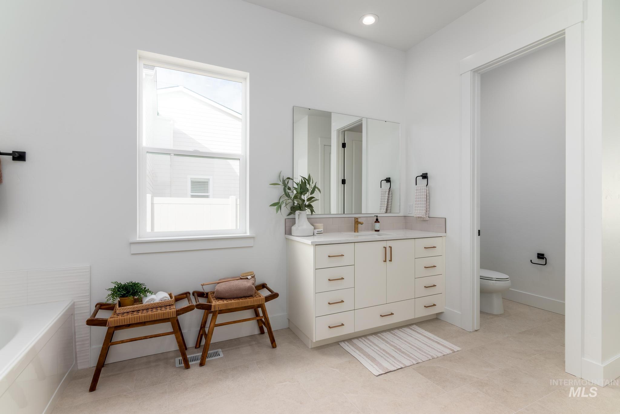 8558 South Silver Smog Way Meridian, ID 83642 - Photo 9 of 13 Full bath featuring vanity, a bath, and recessed lighting