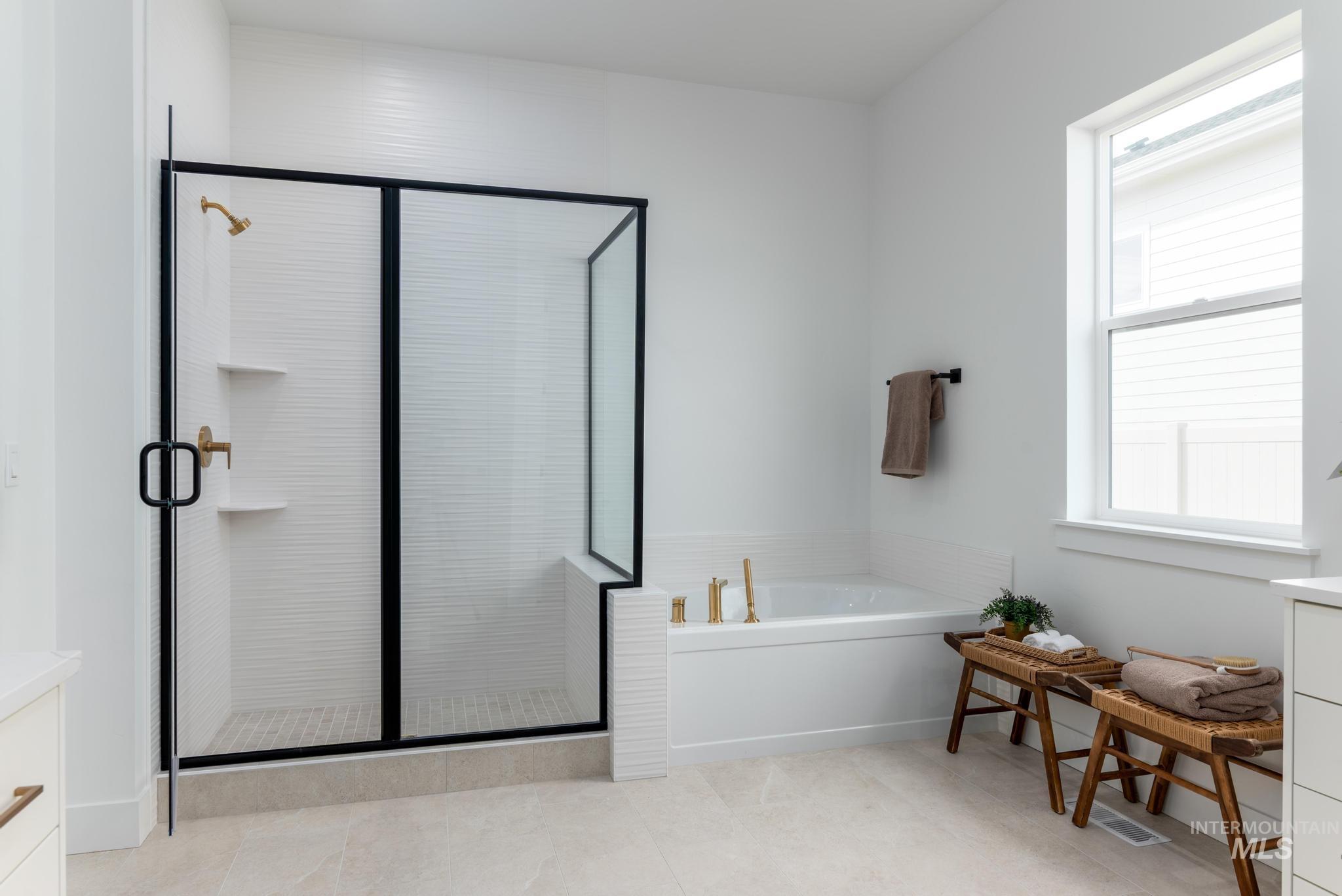 8558 South Silver Smog Way Meridian, ID 83642 - Photo 10 of 13 Bathroom with vanity, a shower stall, and a garden tub