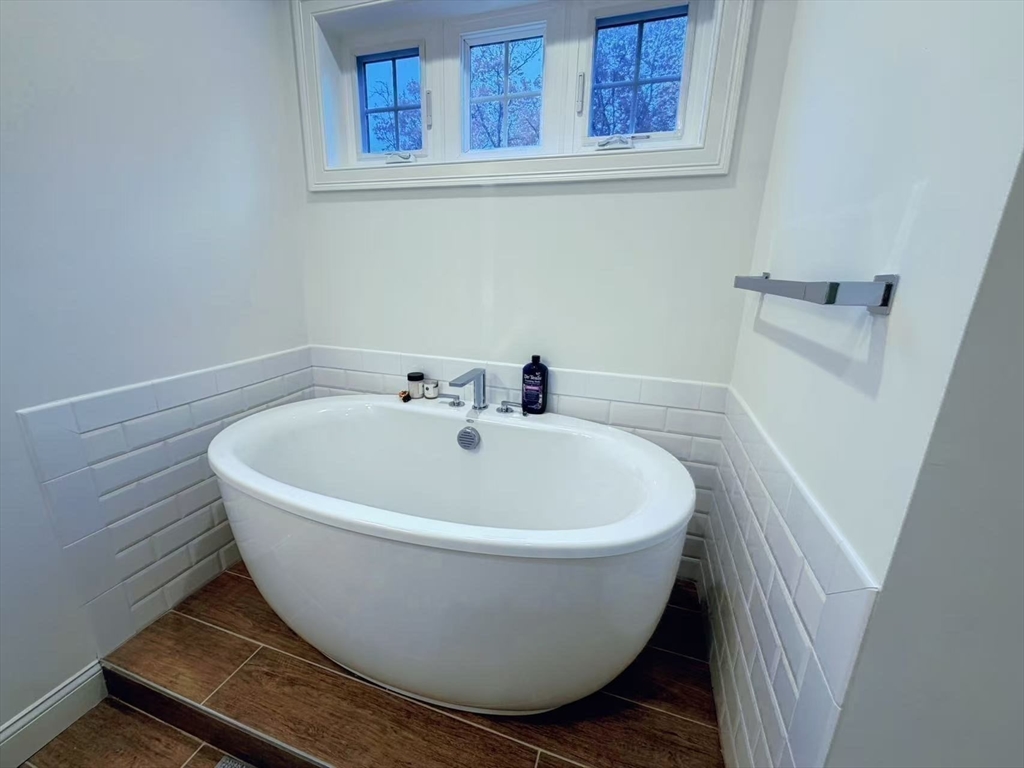 16 Taylor Drive, Unit 1010 Reading, MA 01867 - Photo 14 of 24 a white tub sitting next to a white sink