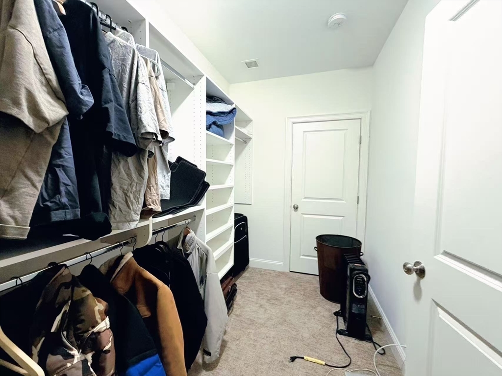 16 Taylor Drive, Unit 1010 Reading, MA 01867 - Photo 17 of 24 a view of walk in closet with clothes and shoes